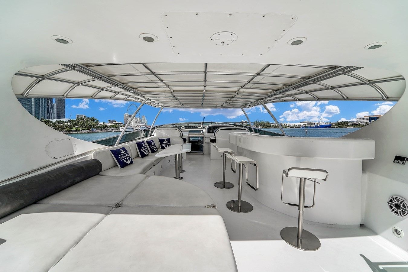 The inside of a yacht with a bar and a view of the water.