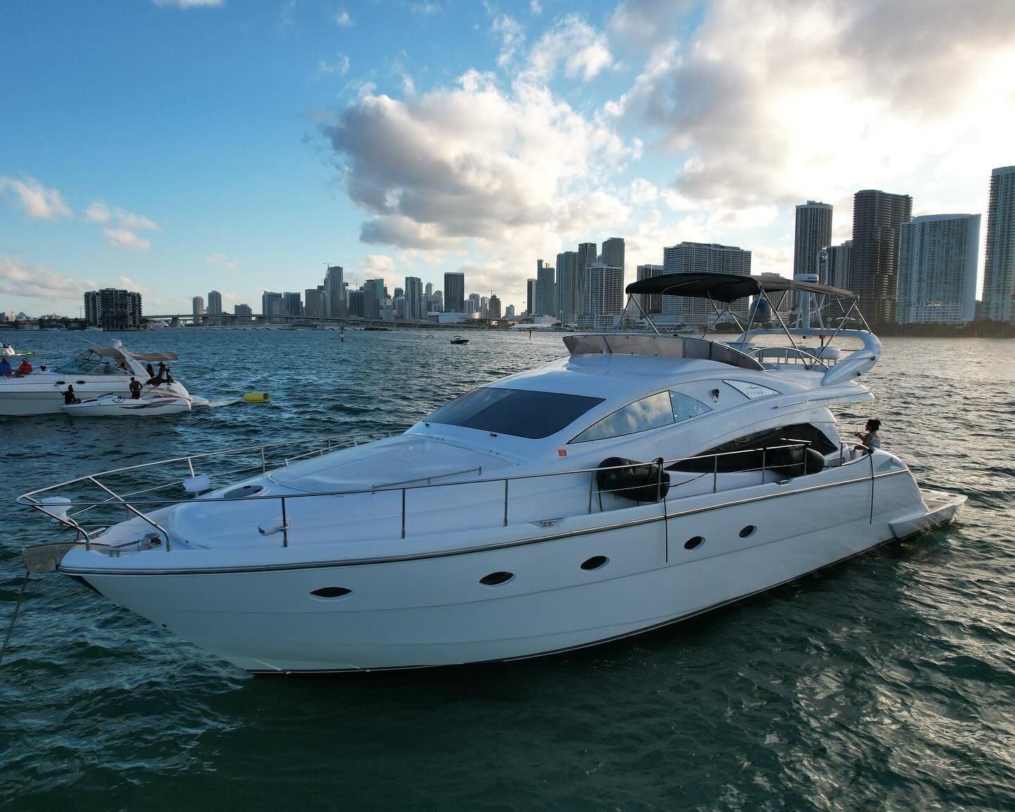 A large white yacht is floating on top of a body of water.