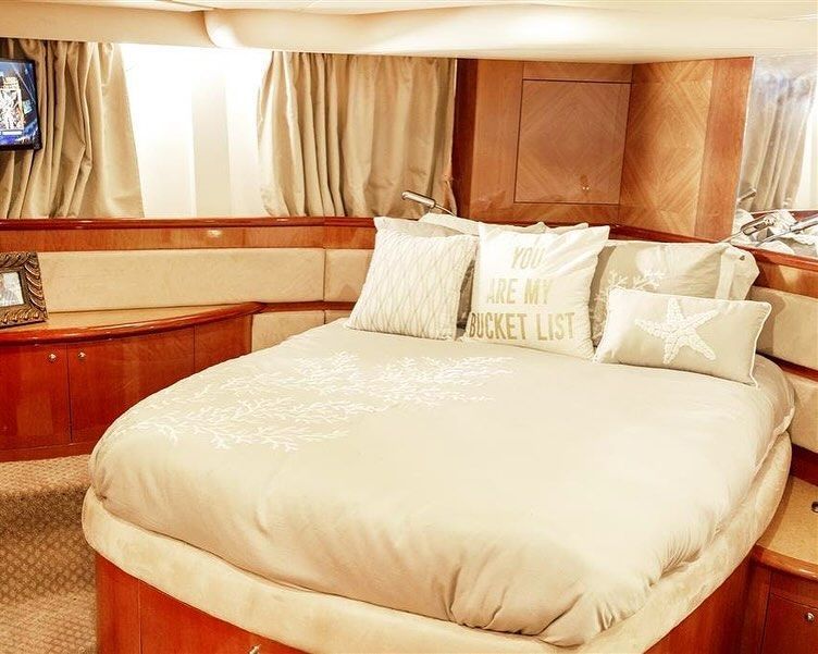 A bedroom on a boat with a large bed and pillows