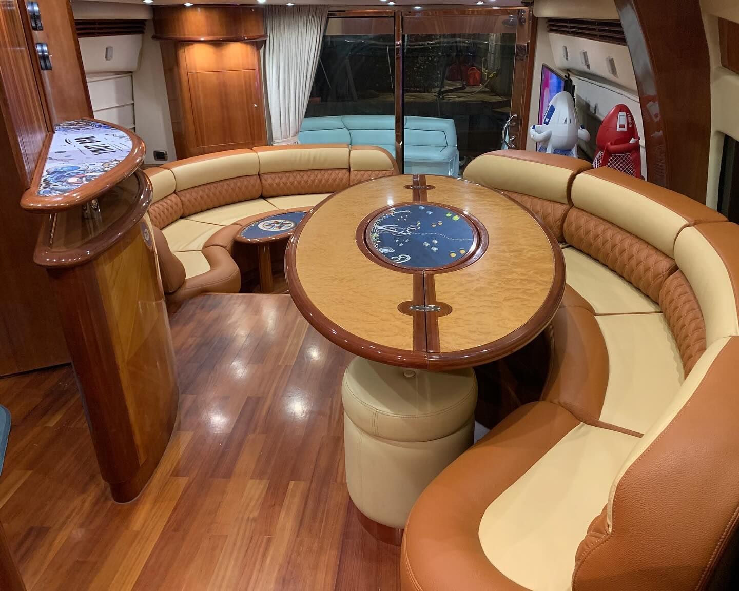 A living room on a boat with a table and couch