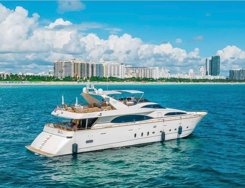A large white yacht is floating on top of a body of water.