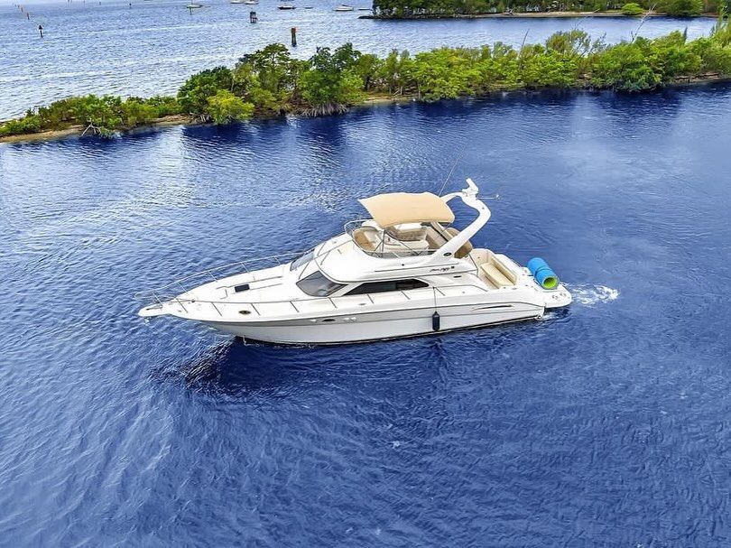 An aerial view of a yacht floating on top of a body of water.