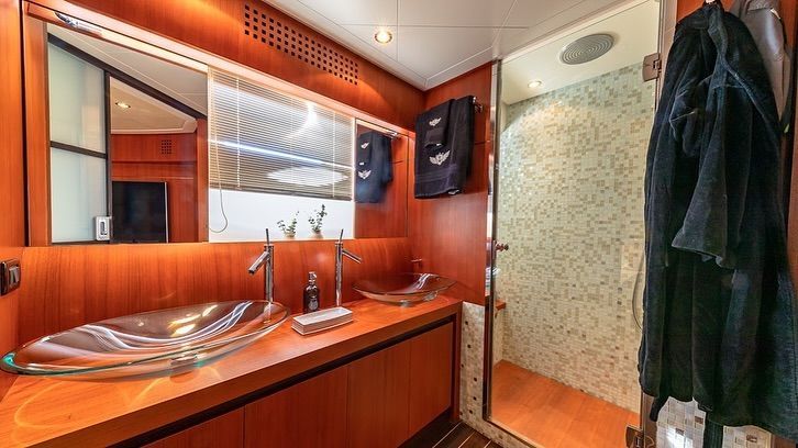 A bathroom with two sinks and a walk in shower.