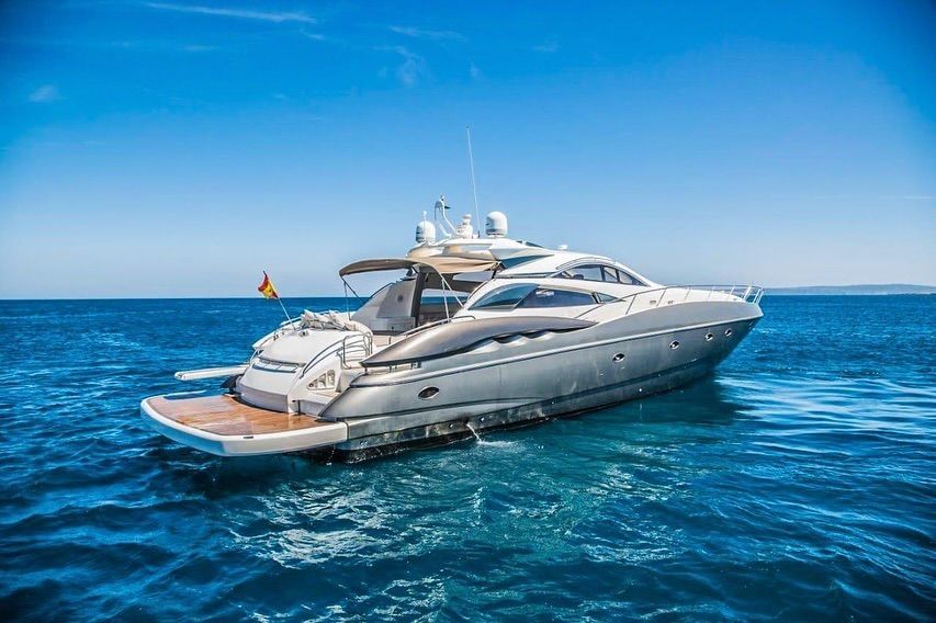 A large yacht is floating on top of a large body of water.