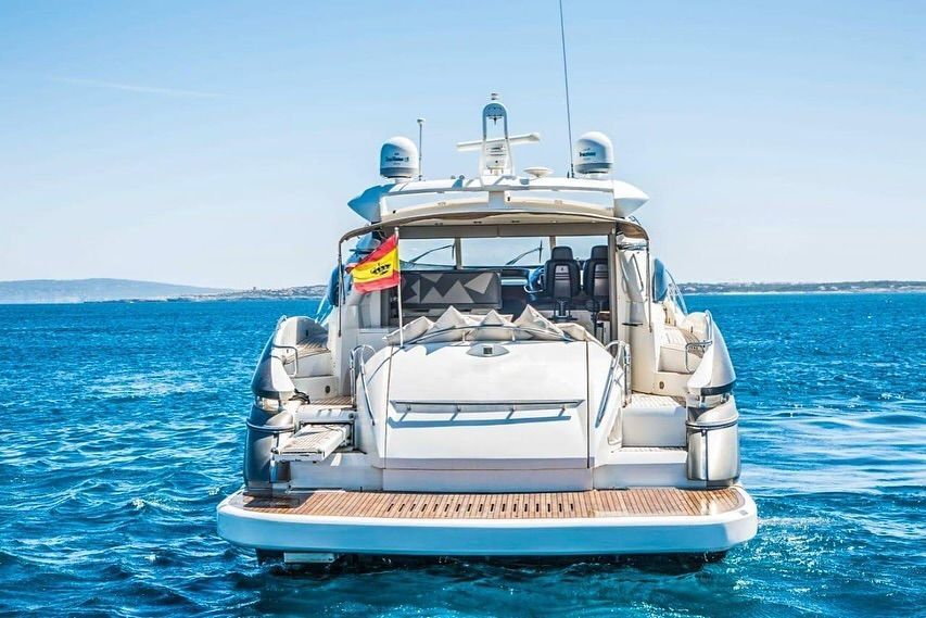 A large white yacht is floating on top of a large body of water.