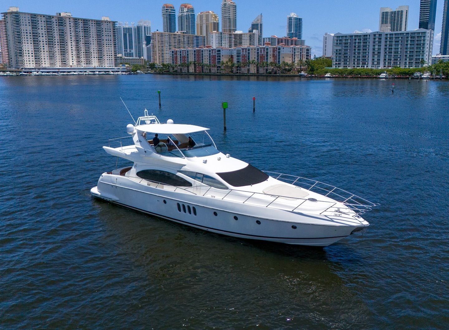 A white yacht is floating on top of a body of water.