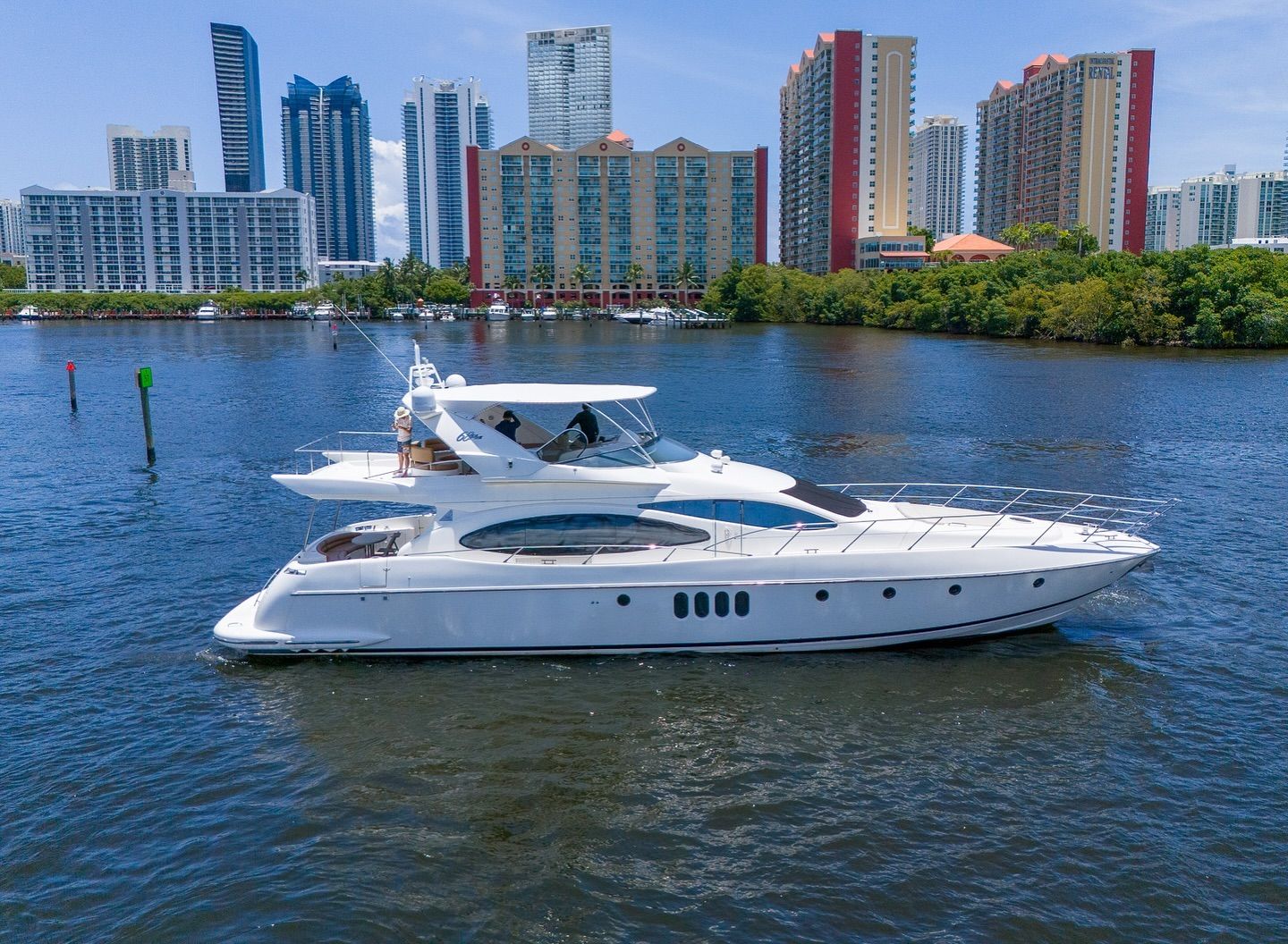A white yacht is floating on top of a body of water.