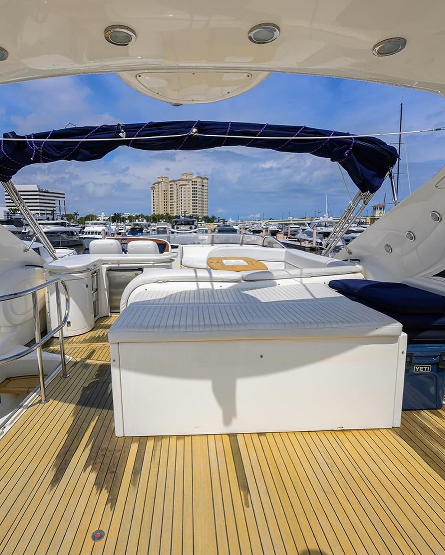 The deck of a yacht with a table and chairs on it