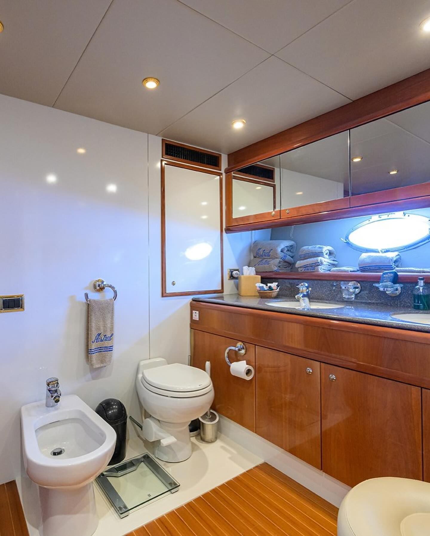 A bathroom with a toilet , bidet and sink