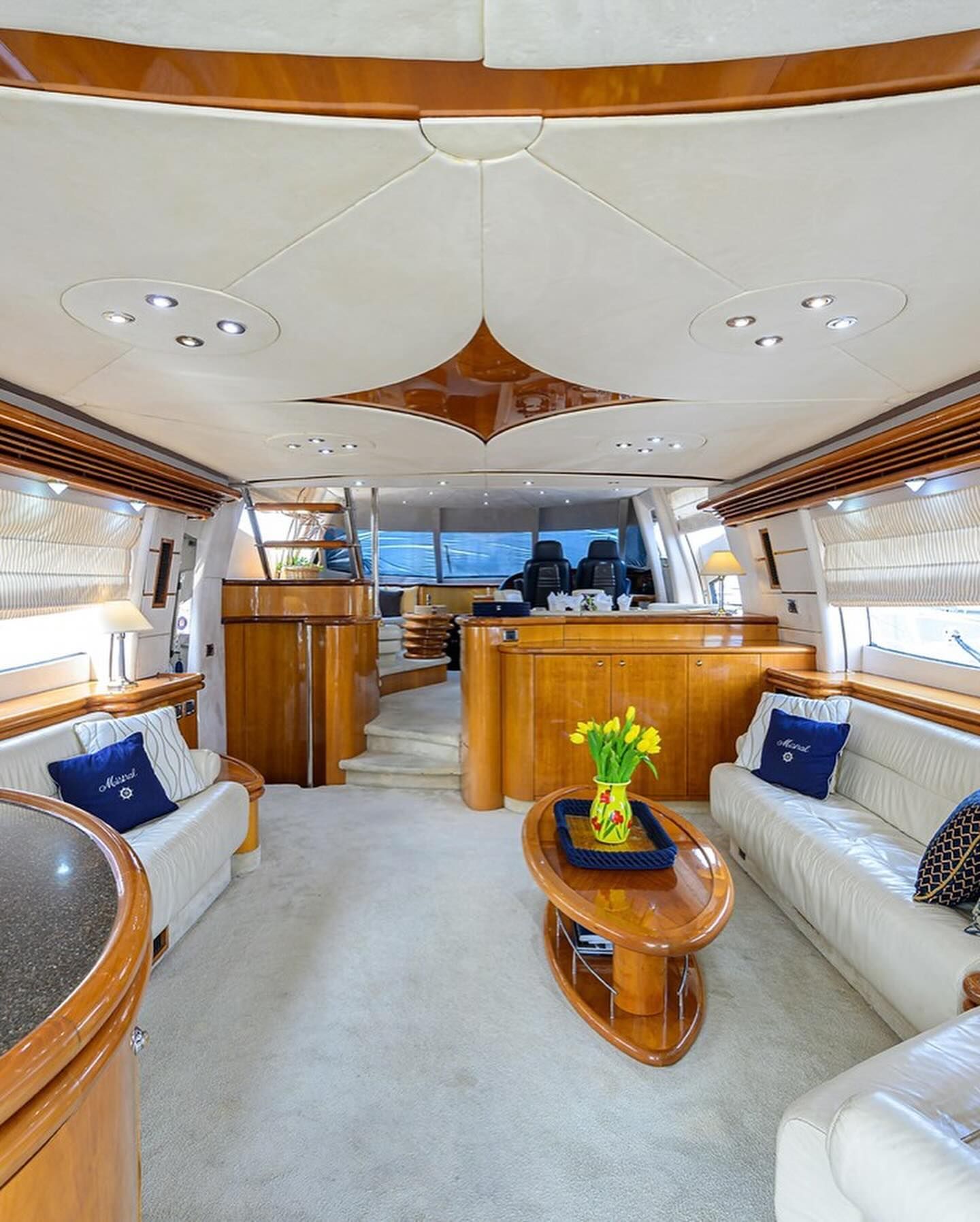 A living room on a boat with two couches and a coffee table.