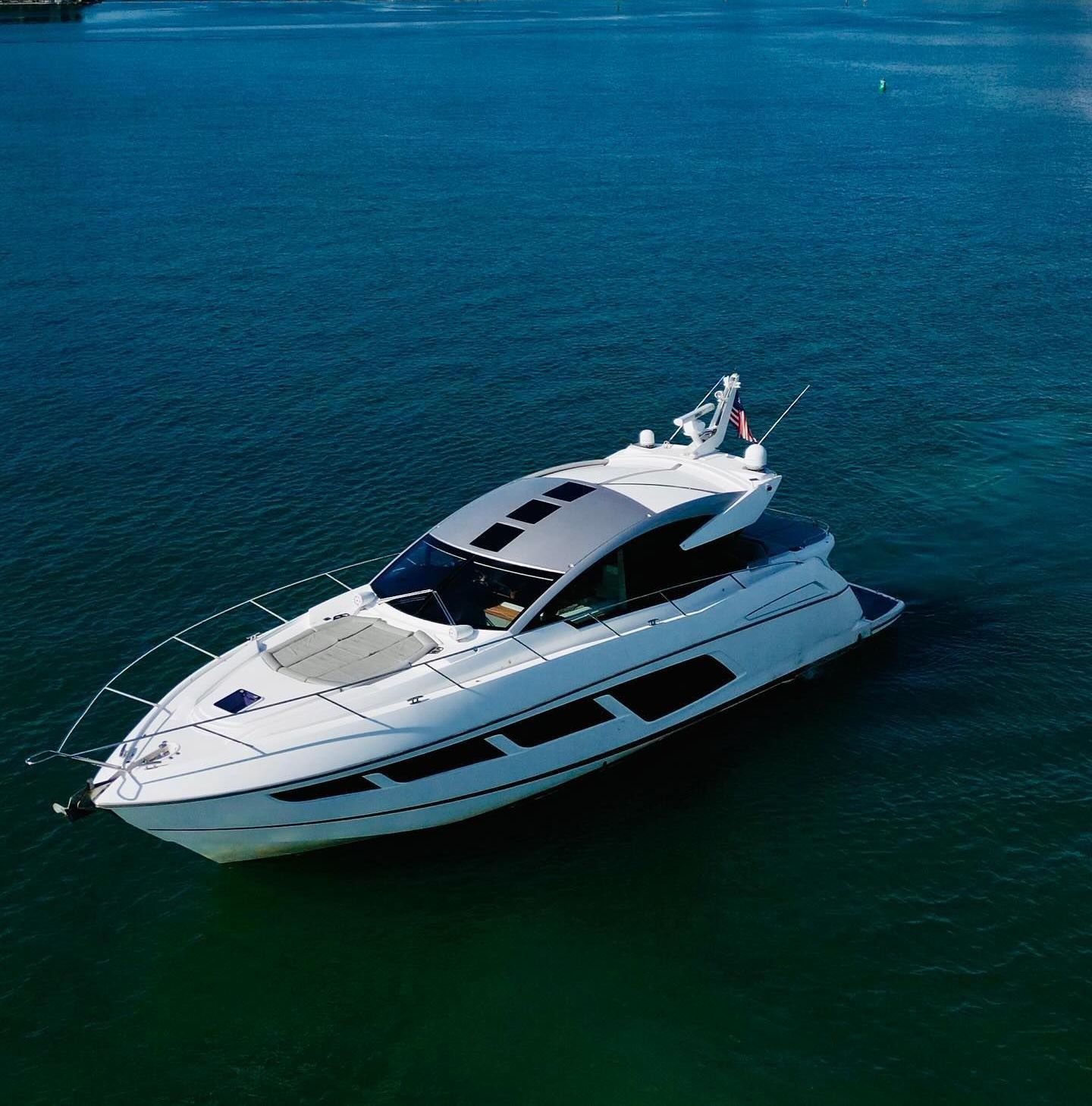A large white boat is floating on top of a body of water