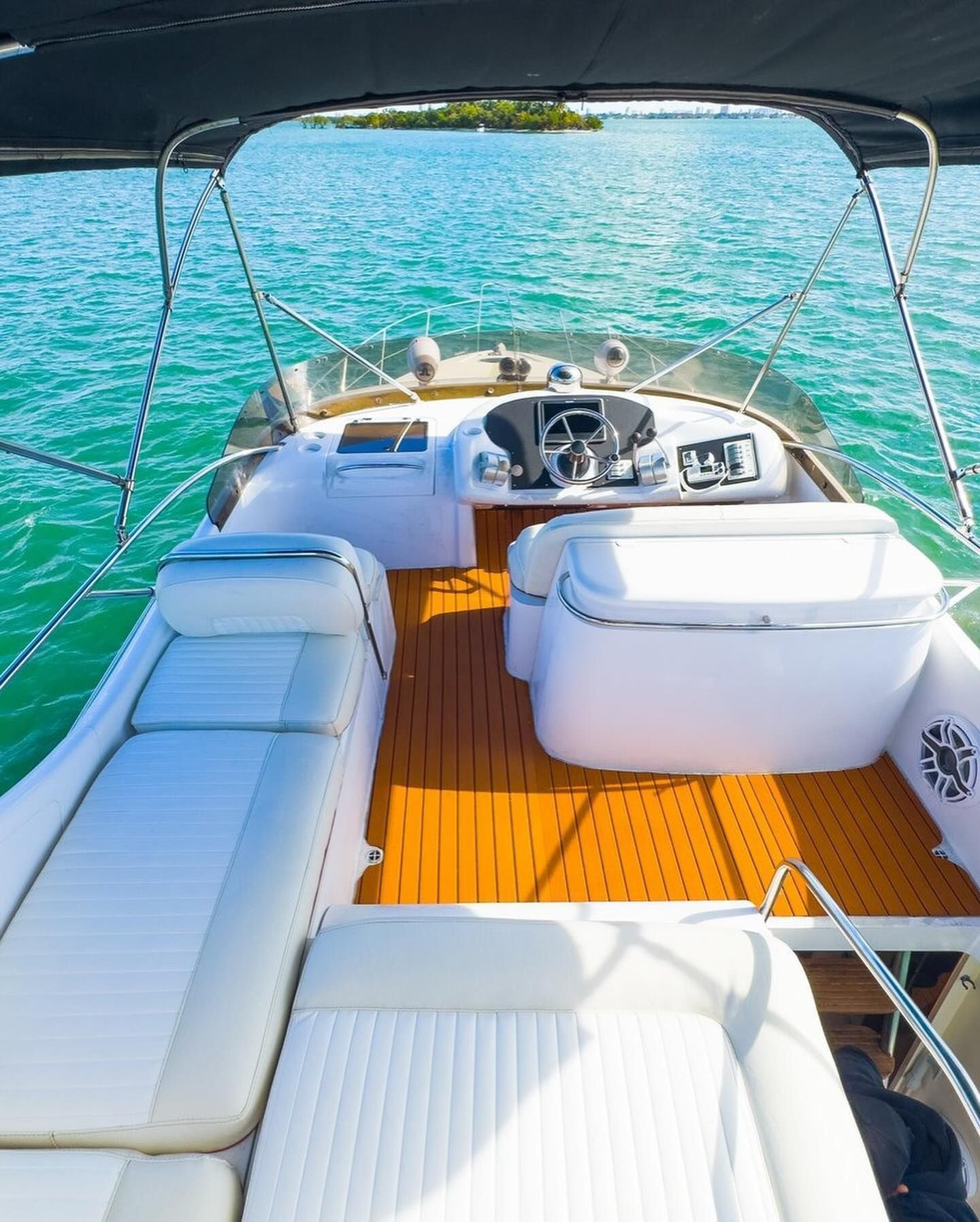 A white boat is floating on top of a body of water.