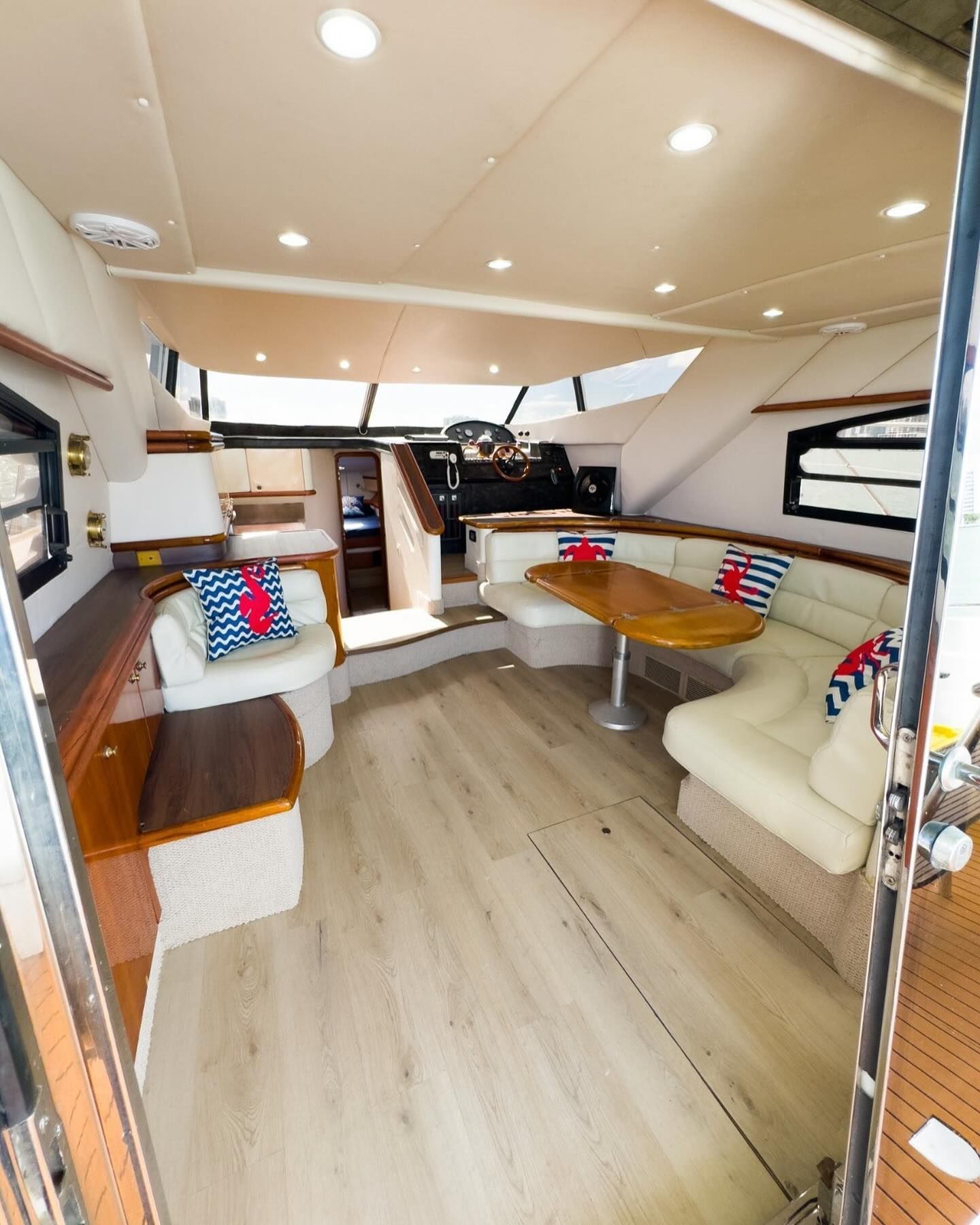 A living room on a boat with a table and chairs