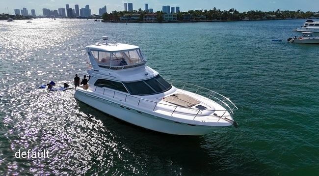 A white yacht is floating on top of a body of water.