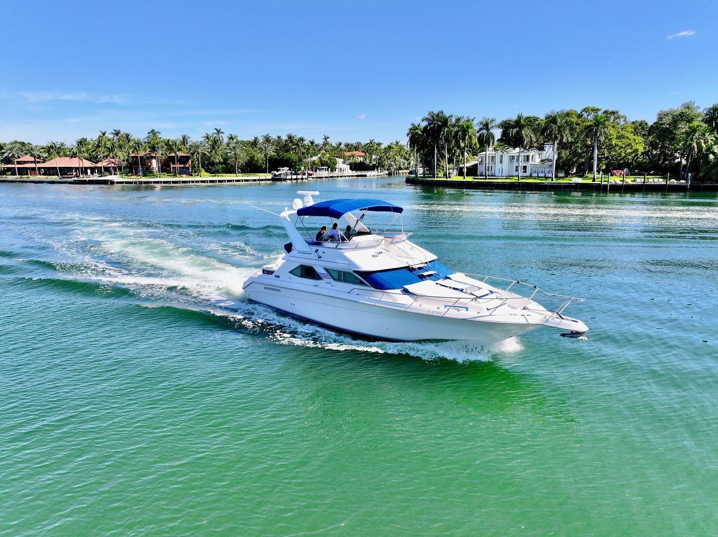A white boat is floating on top of a body of water.