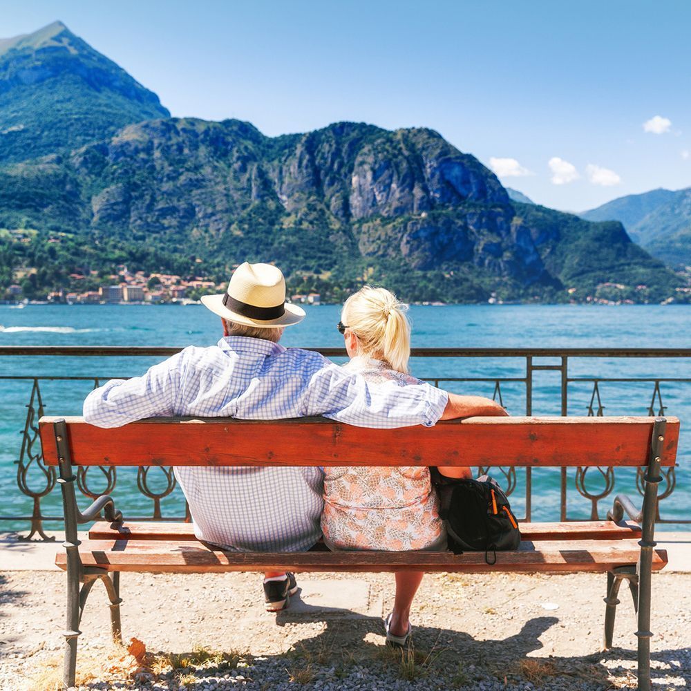 Couple sitting on a bench enjoying Lake Como views