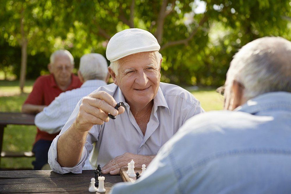 anziani felici mentre giocano a scacchi