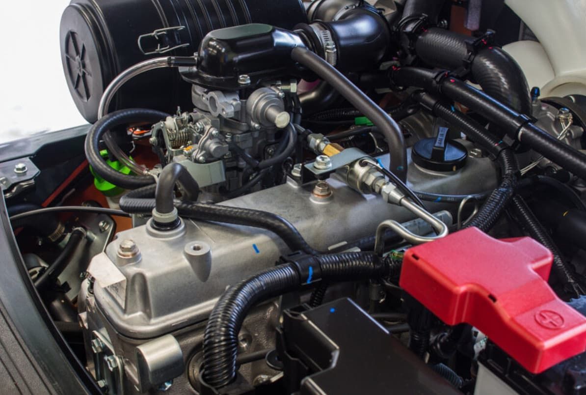 A Close Up Of A Car Engine With A Red Battery — Brad's Auto Electrical in Mareeba, QLD