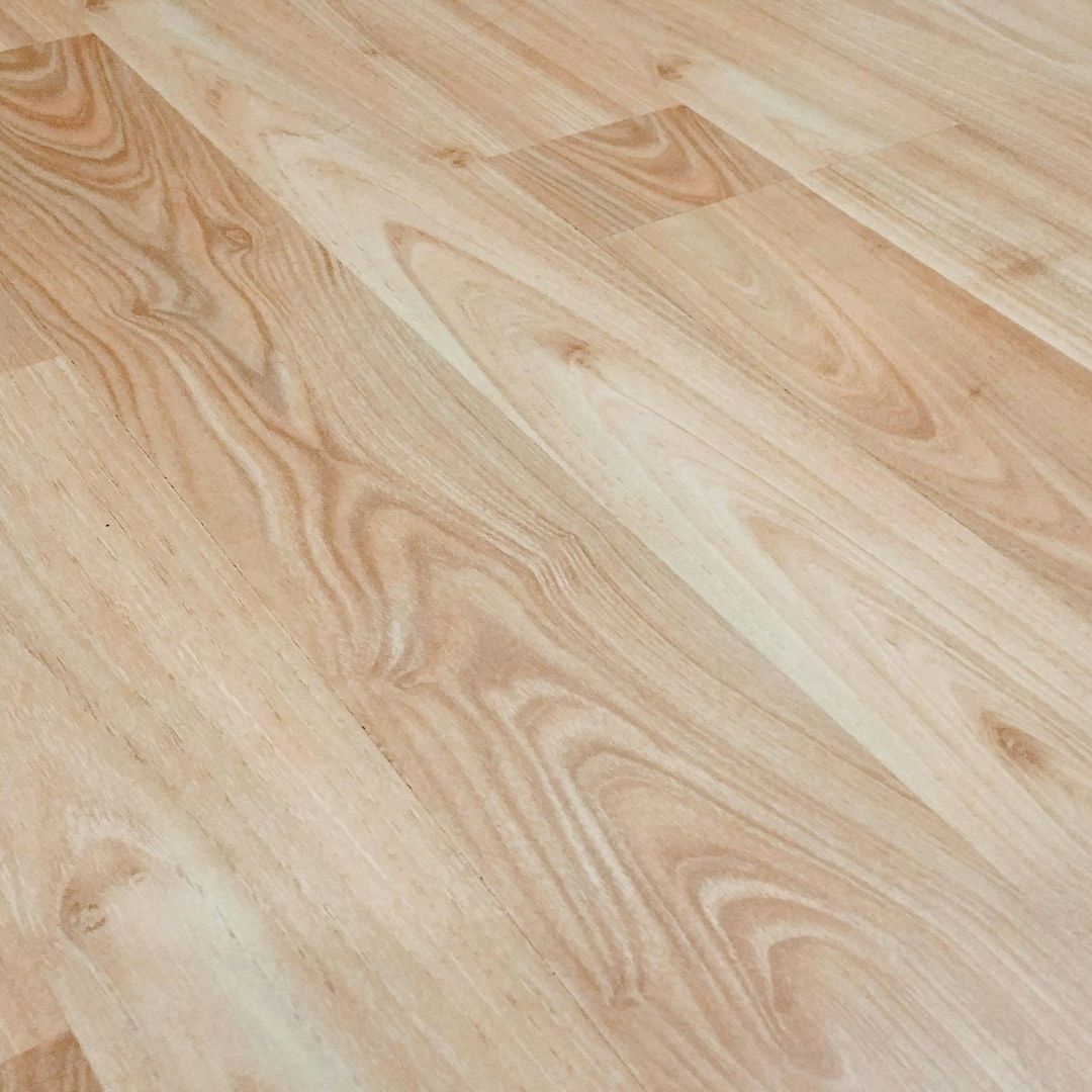A close up of a wooden floor with a grain pattern.