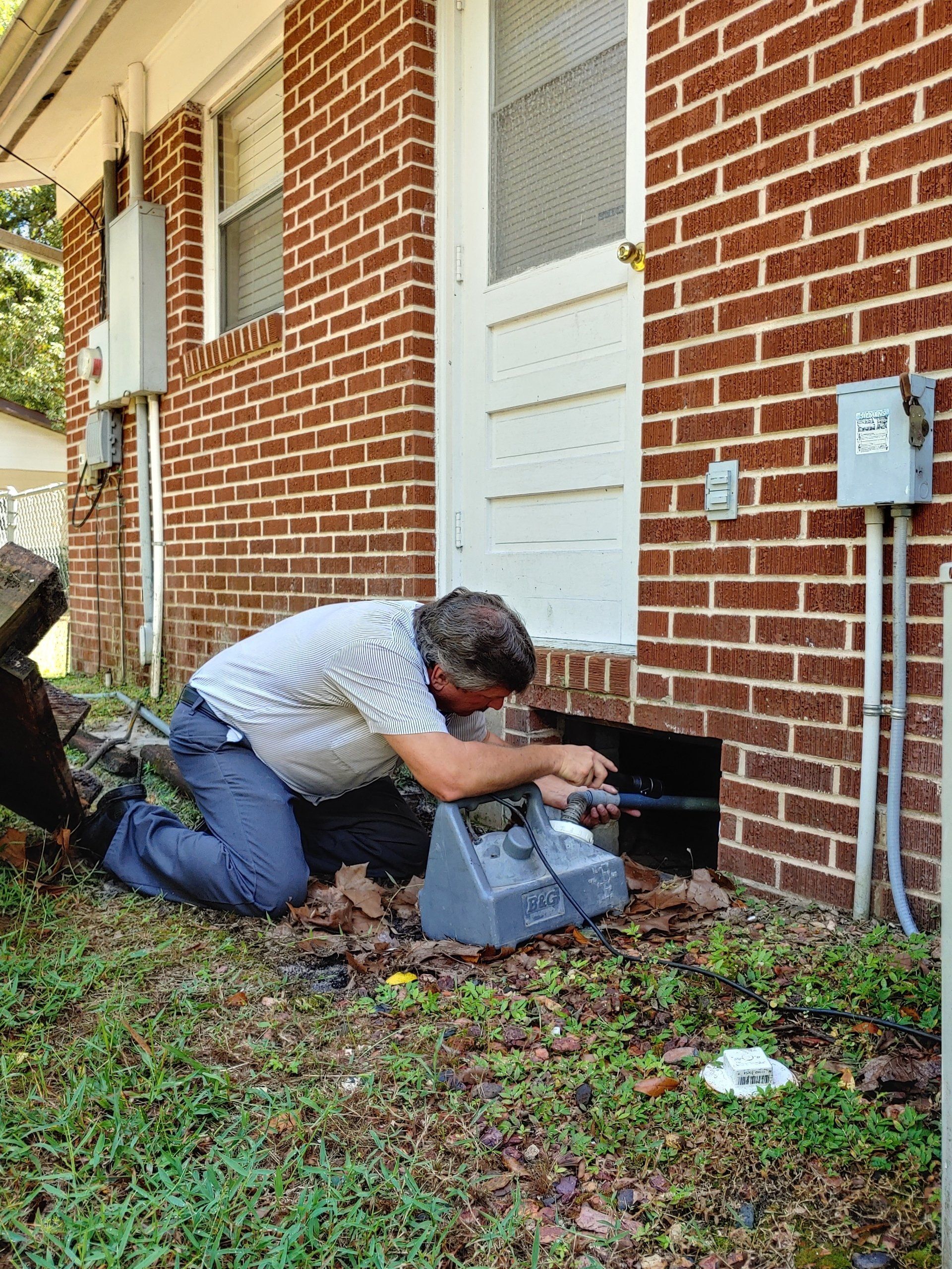 Pest Extermination — Exterminator Spraying on Home Floor in Tavares, FL