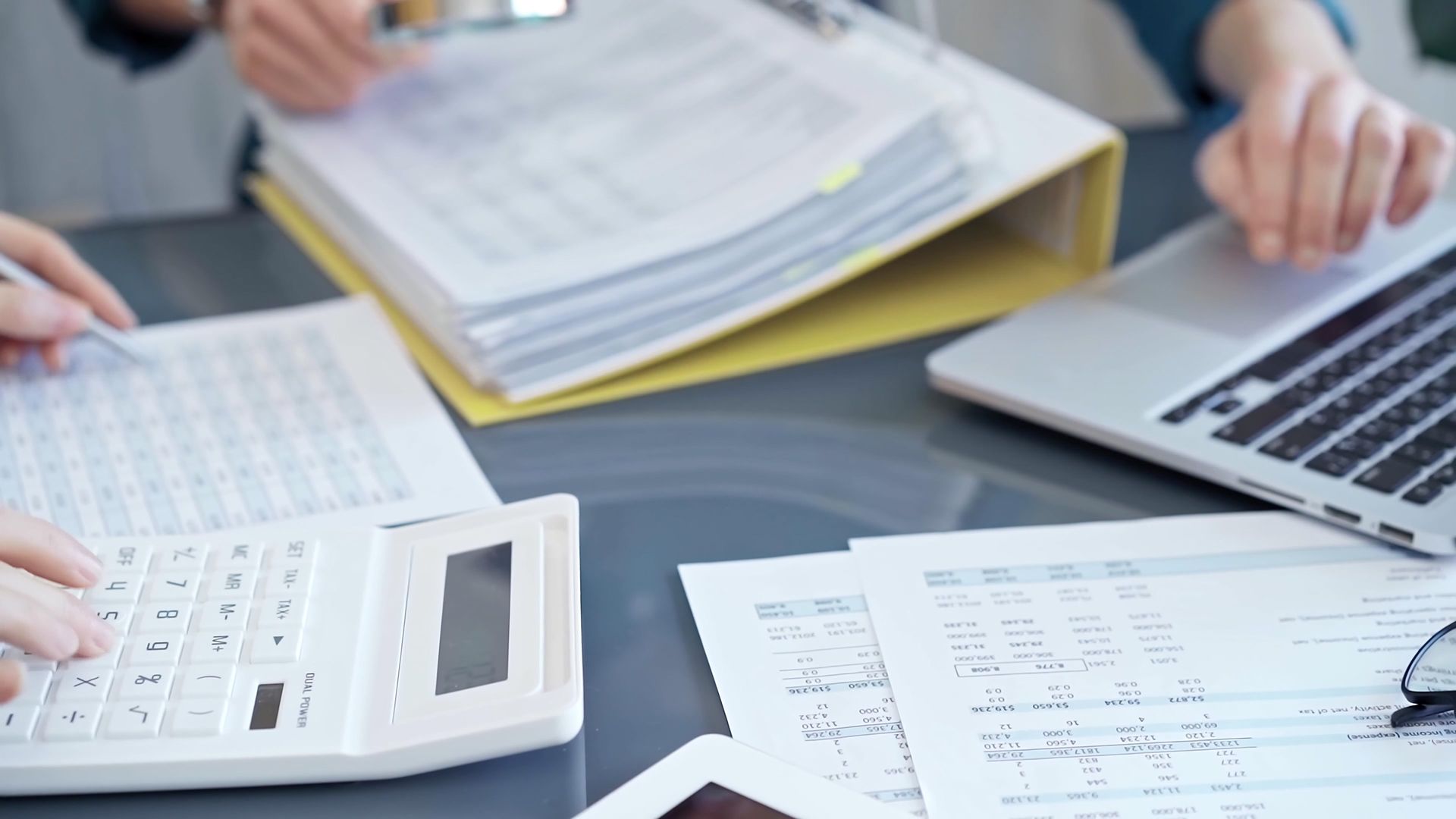 Hands Working on Financial Documents With a Calculator — Careful Books in Tablelands, QLD