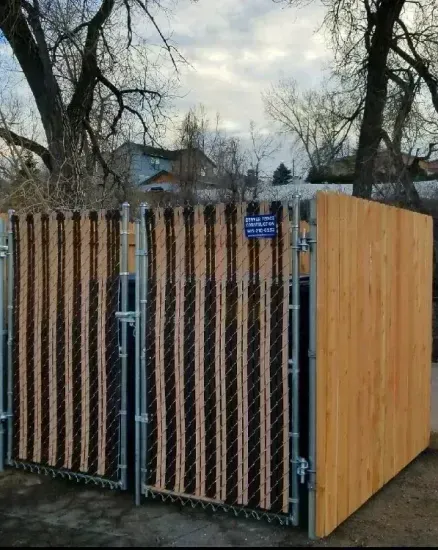 A wooden fence with a chain link fence around it