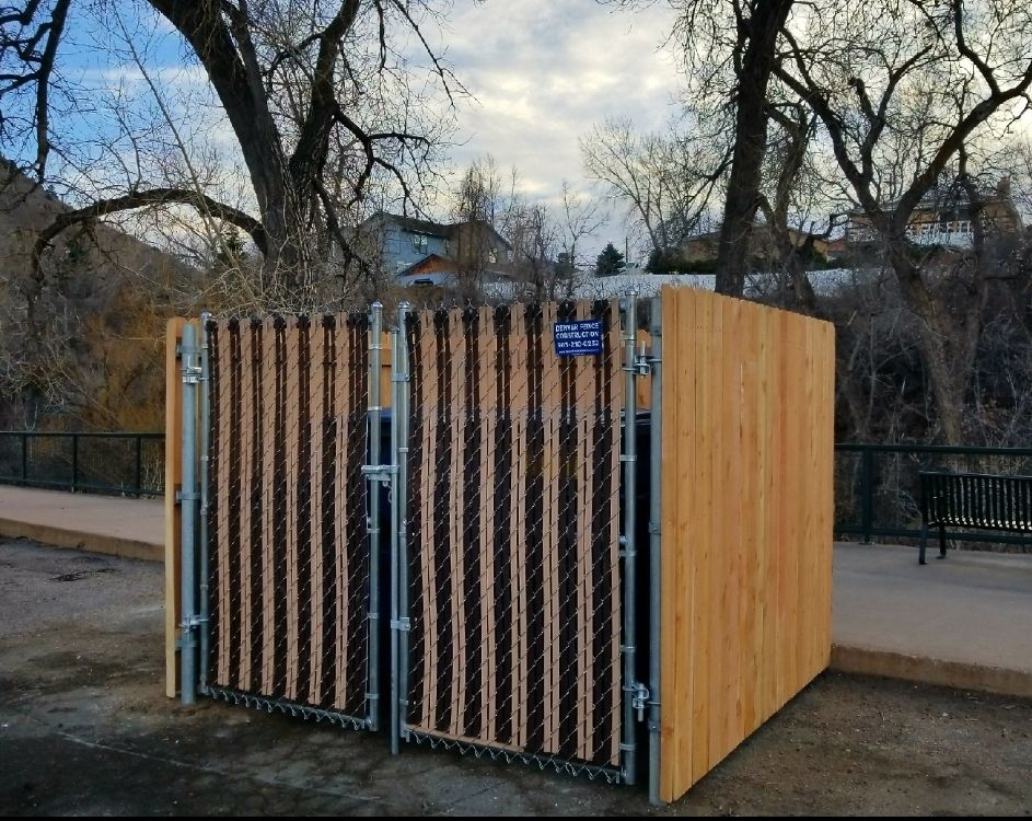 A wooden fence with a chain link fence around it