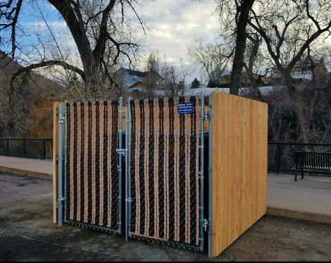 A wooden fence with a chain link fence around it