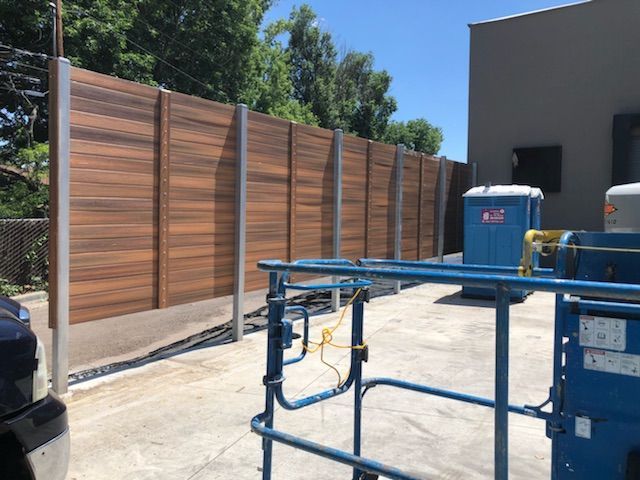 A wooden fence is being built in front of a building