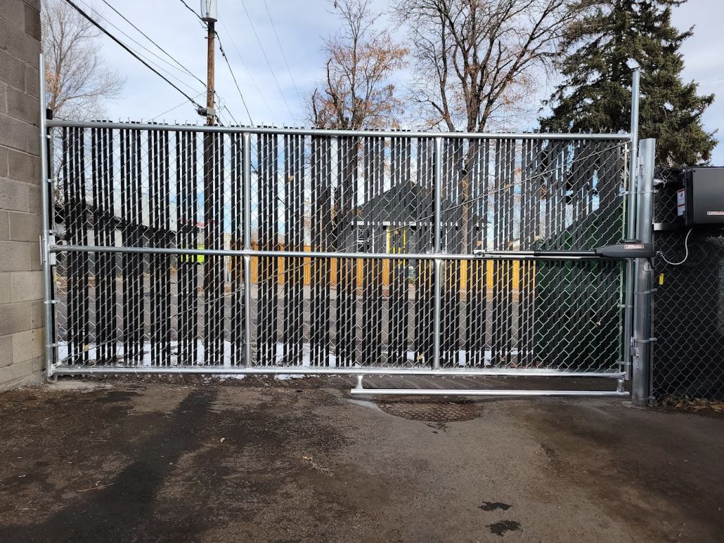 A sliding gate with a chain link fence behind it
