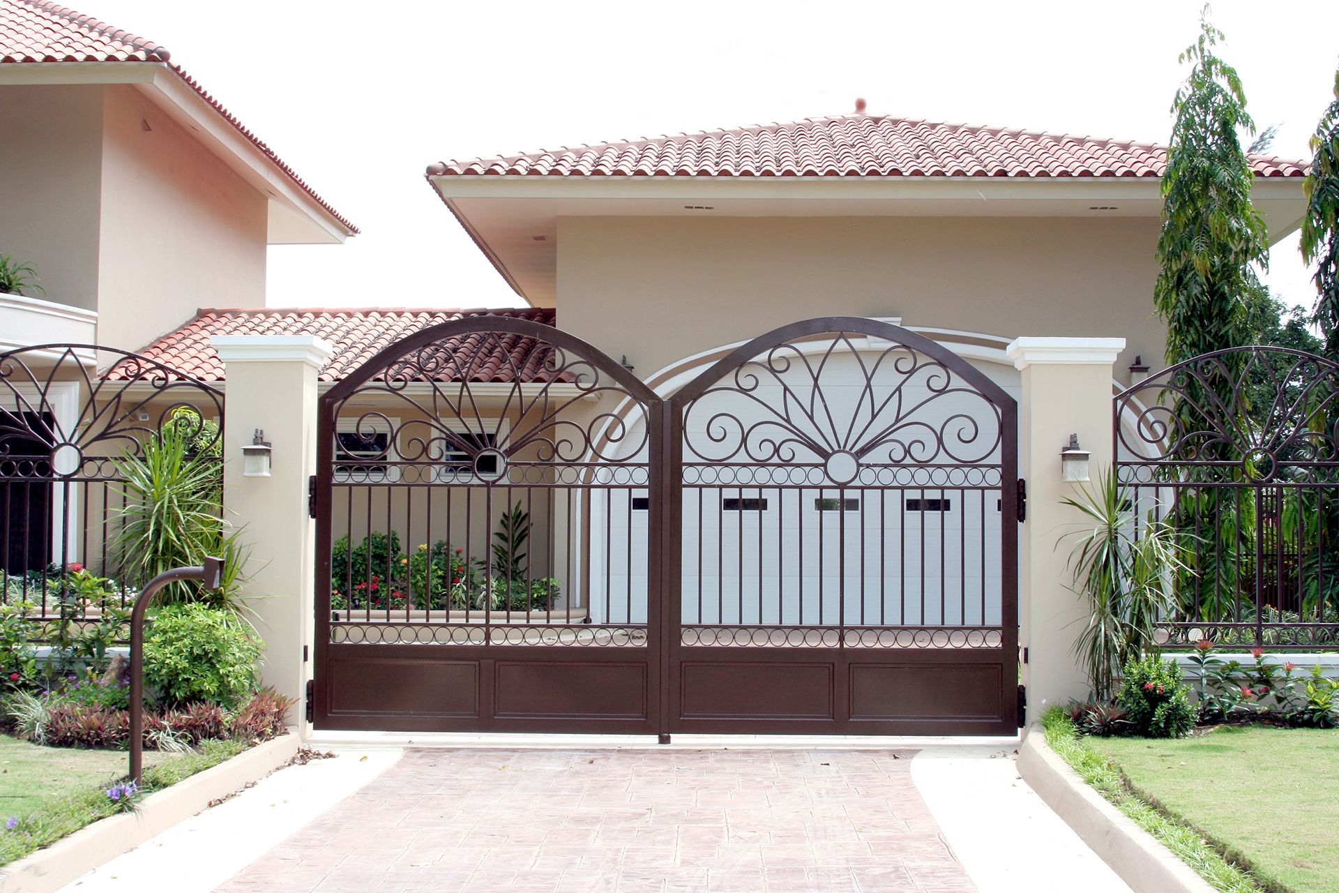 A house with a wrought iron gate in front of it