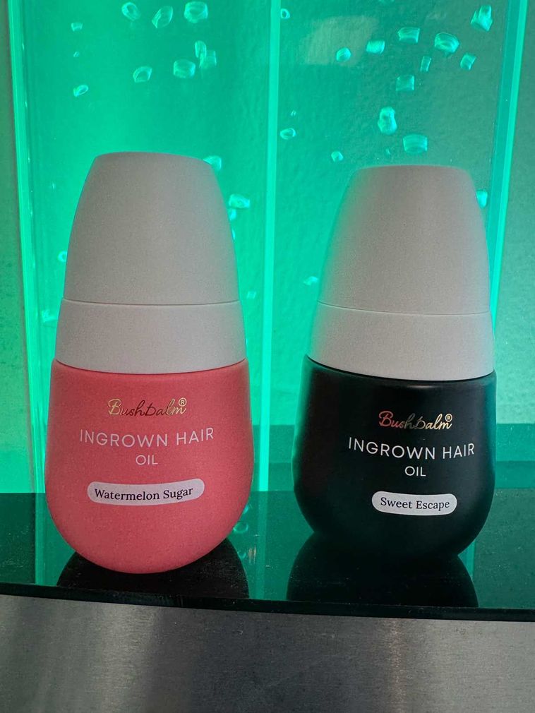 Two cosmetic bottles, pink and black, labeled 