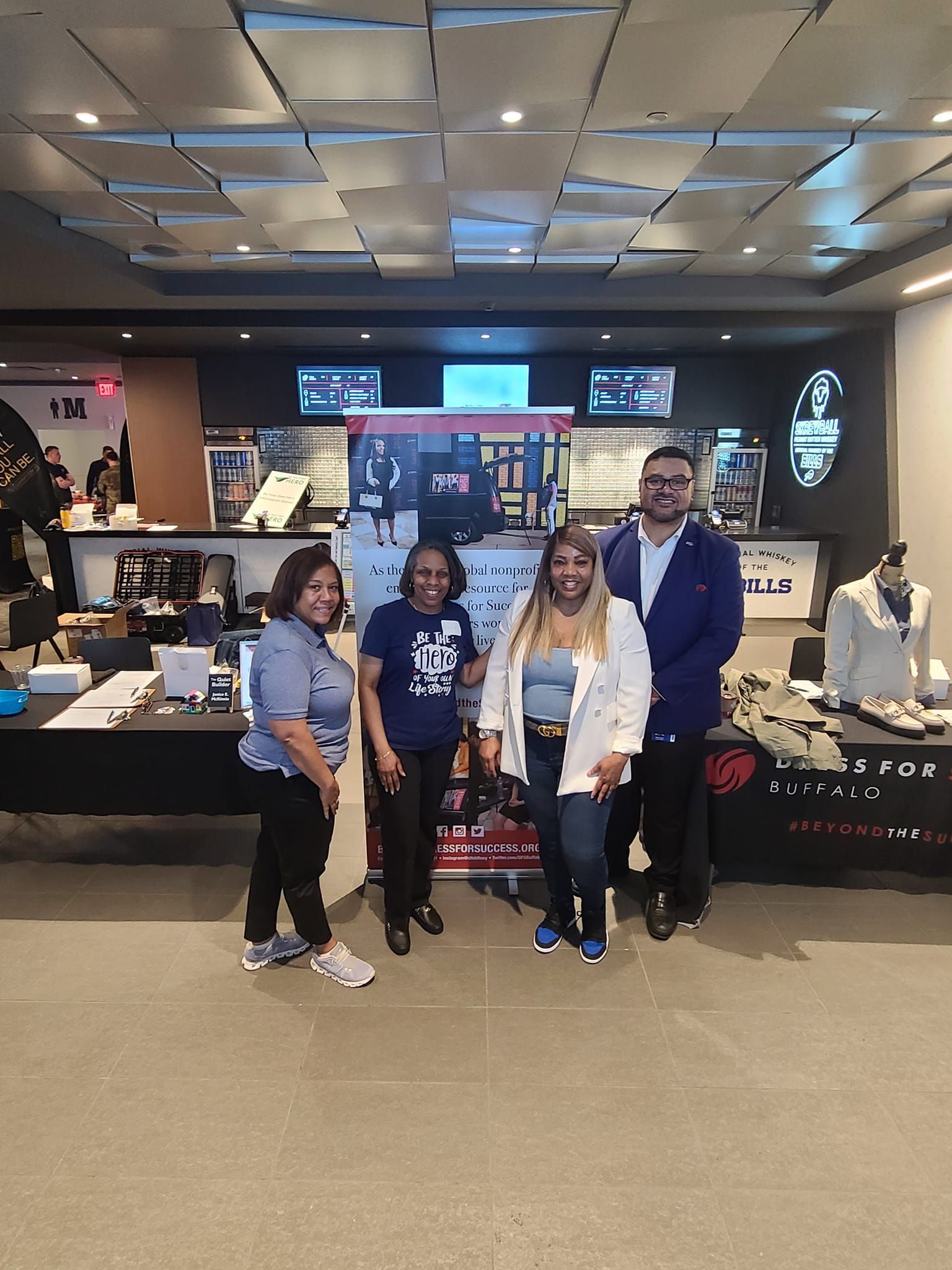 A group of people are posing for a picture in a room.
