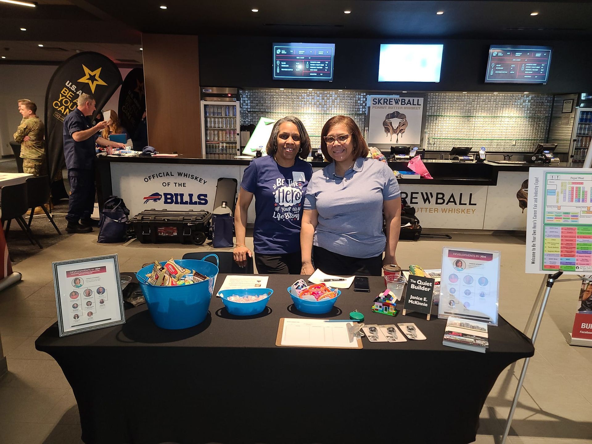 Two women are standing in front of a table in a restaurant.