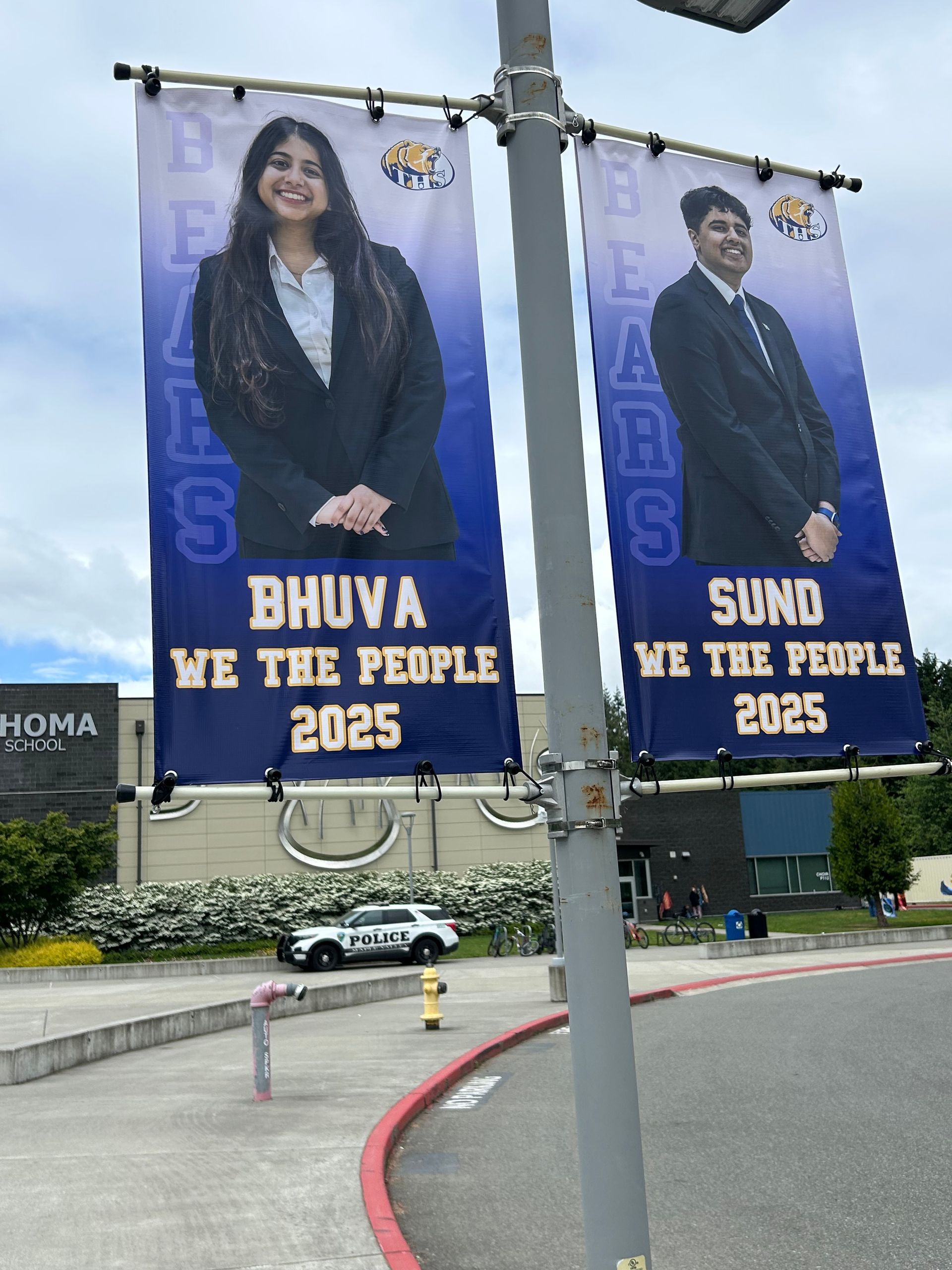 Two banners on a pole that say bhuva we the people 2025