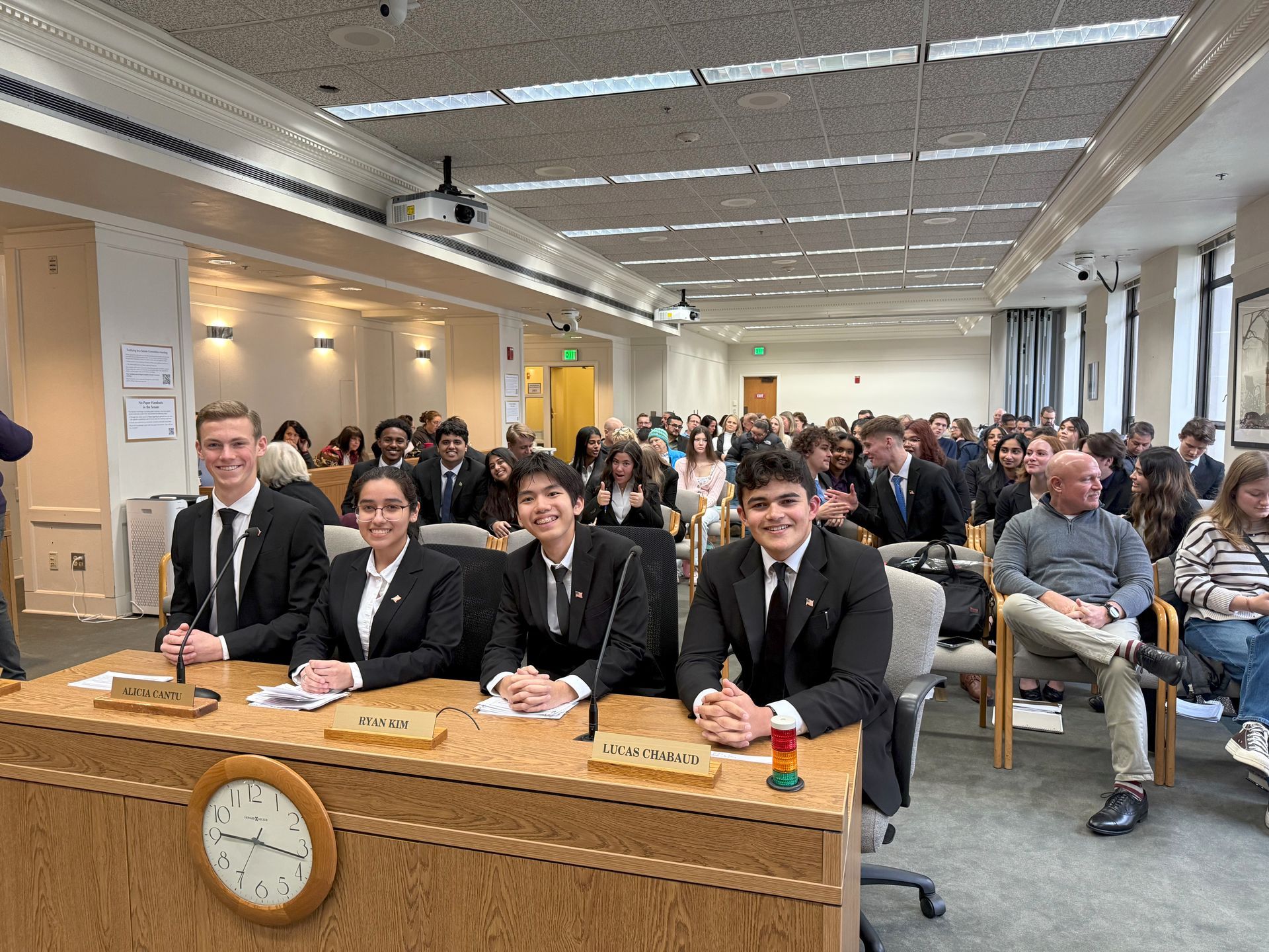 A group of people are sitting at a table in a room.