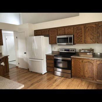 A kitchen with stainless steel appliances and wooden cabinets