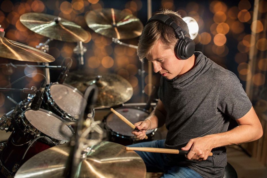 boy  practicing his hands on drums