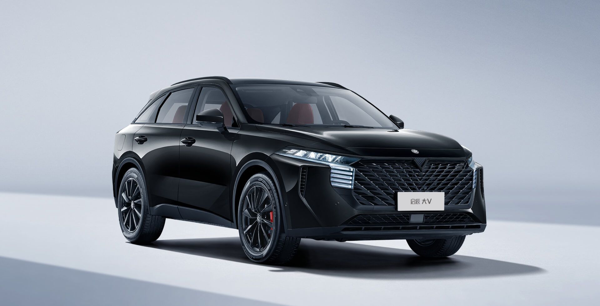 Black SUV car on a white background with a modern front grill design.