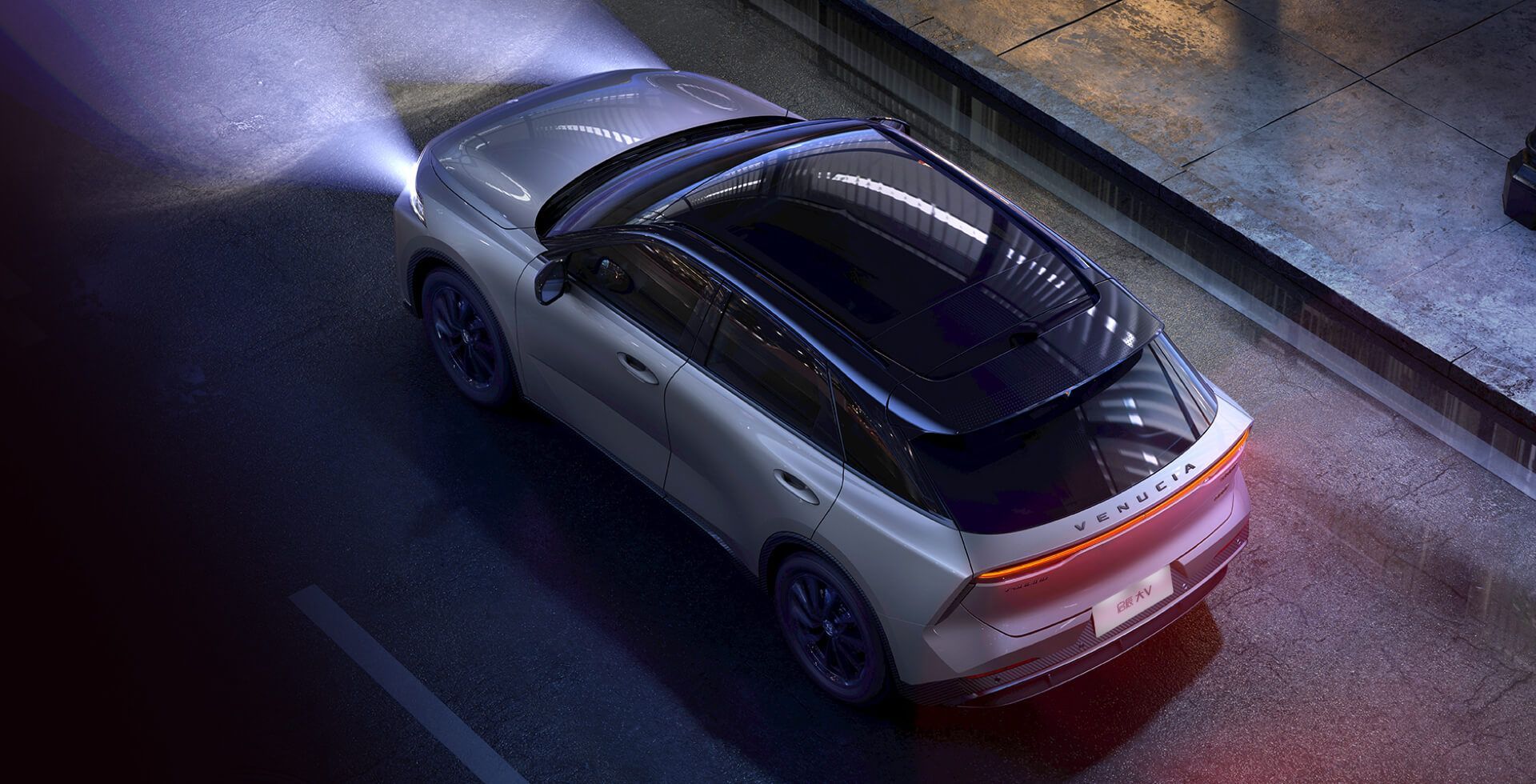 Silver electric car driving on a street at night, with headlights on, and a dark glass roof.