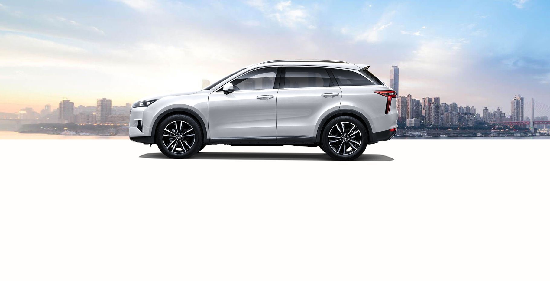 White SUV parked, cityscape background.