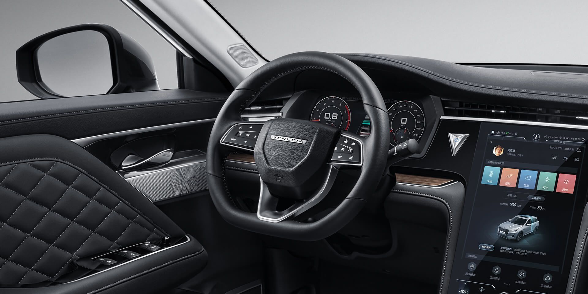 Car interior with black leather steering wheel and dashboard, touchscreen display, and quilted door panel.