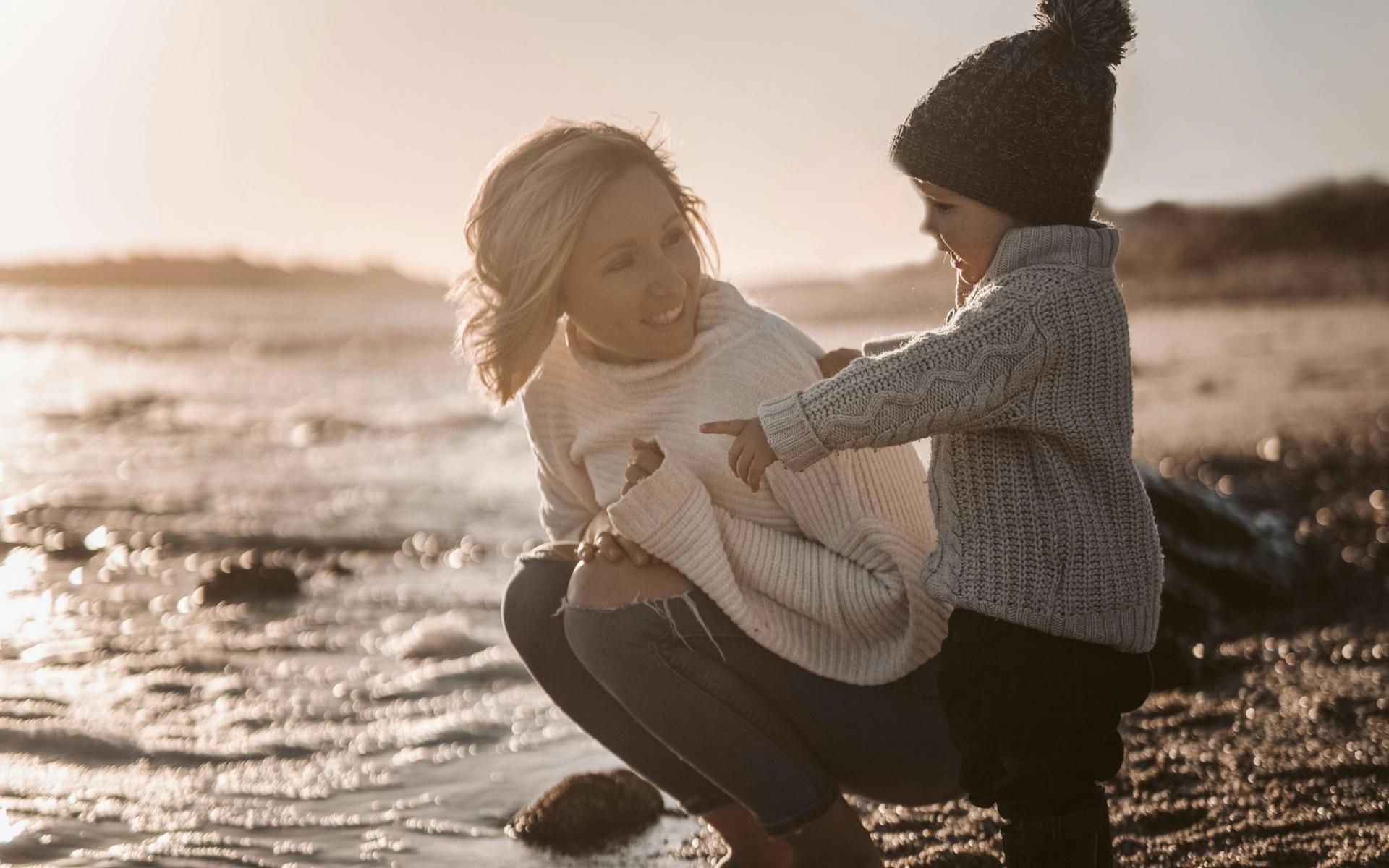 Mother & Child sitting by the beach