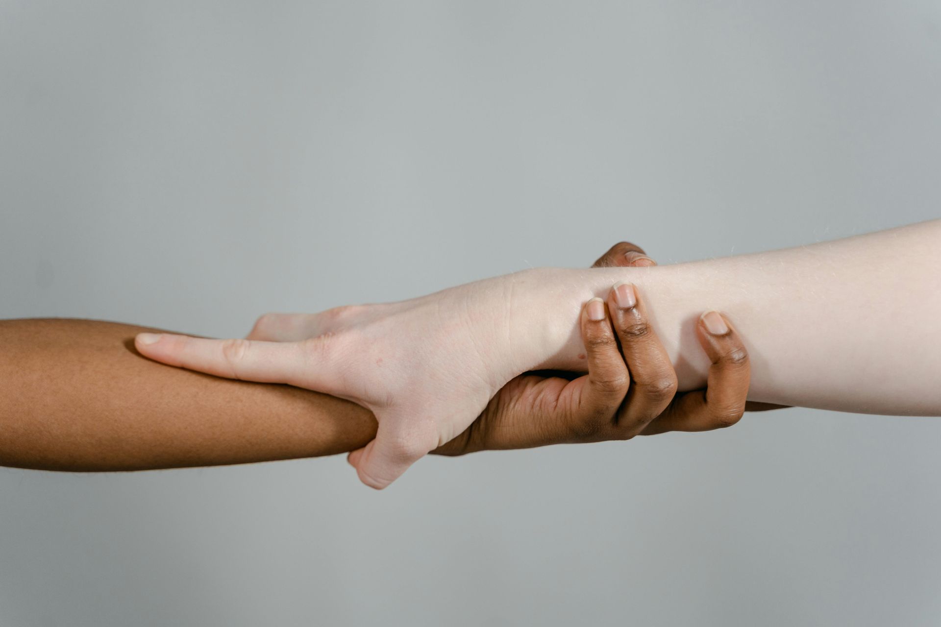 Two people reaching towards one another to connect