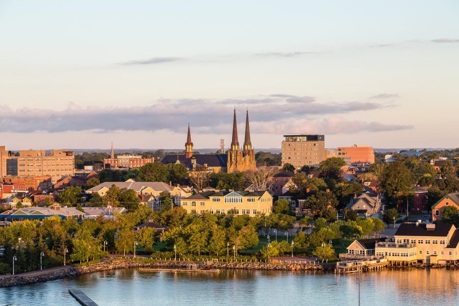 An aerial view of a city overlooking a body of water.