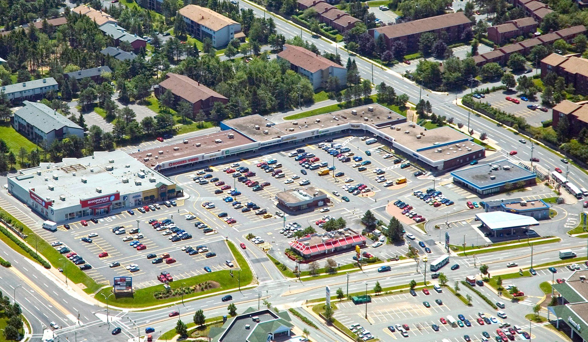 An aerial view of a shopping center in a residential area