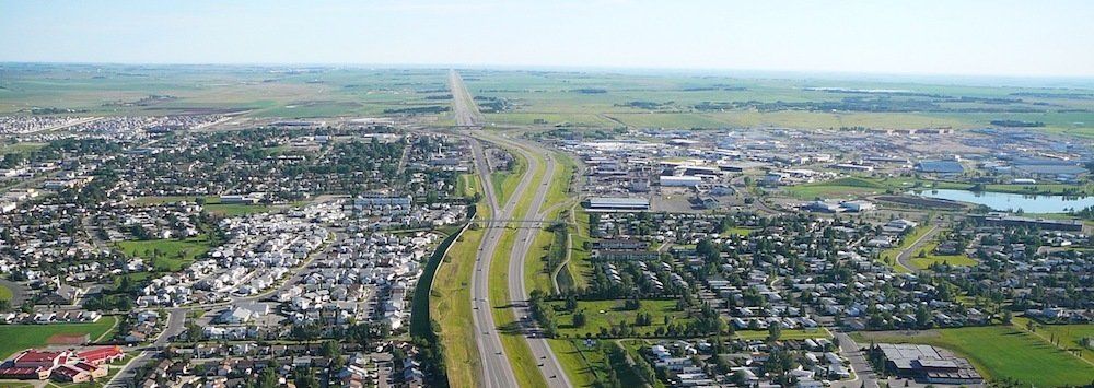 An aerial view of a city with a highway going through it.