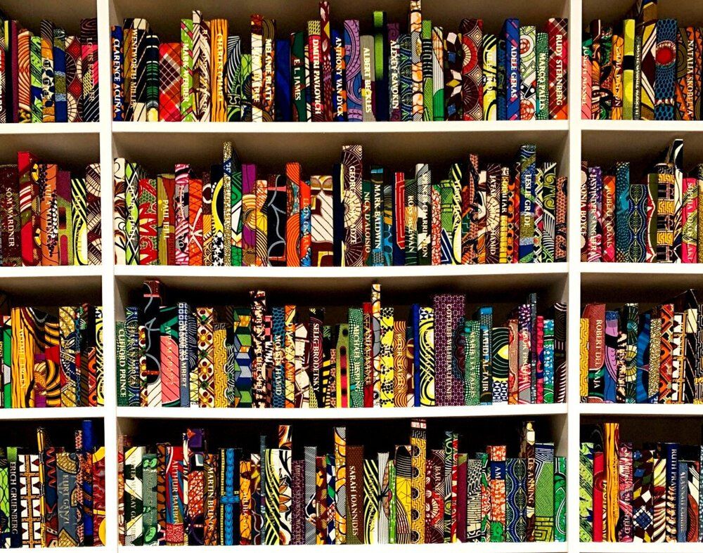 A bookshelf filled with many different colored books