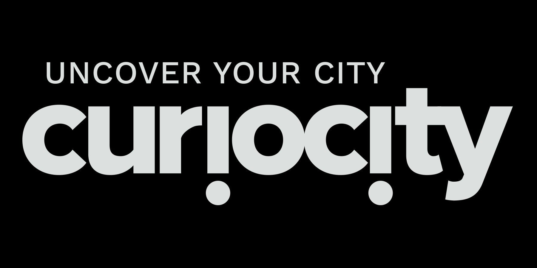 The logo for curiosity is white on a black background