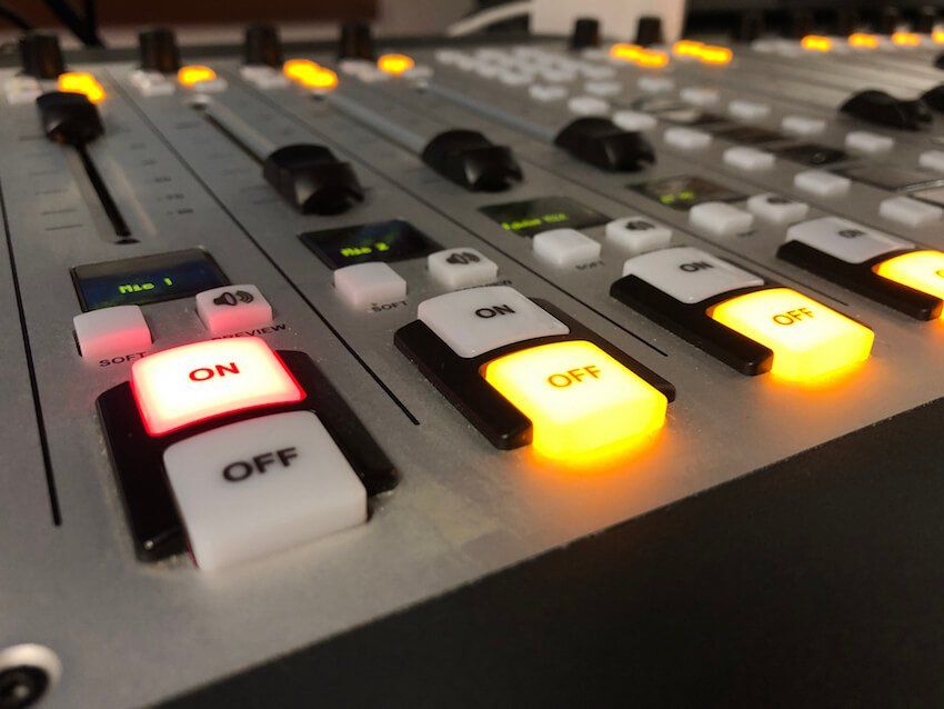 On and off buttons are lit up on a mixer